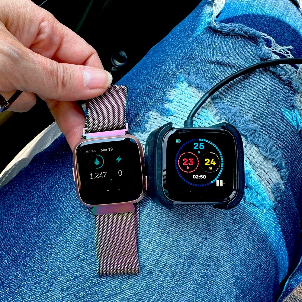 2 Fit Bit Versa with charging pad and one band.